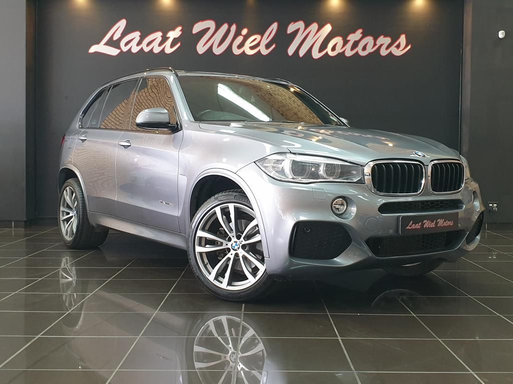 Silver BMW SUV displayed in Laat Wiel Motors showroom