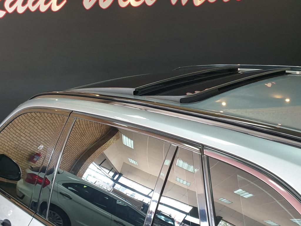 Silver SUV with roof rails and tinted windows