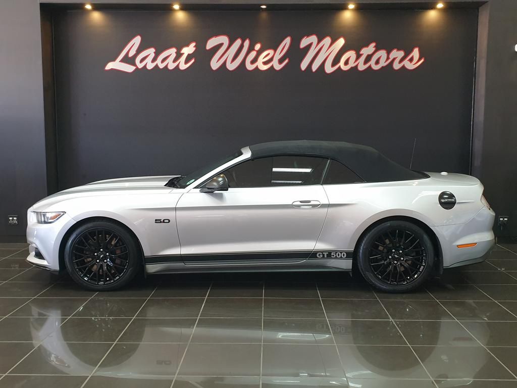 White Ford Mustang GT500 convertible displayed in showroom