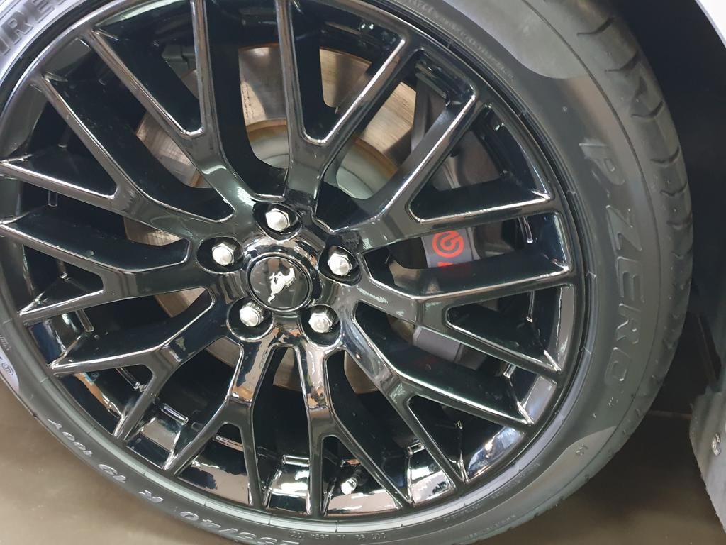 Close-up of black alloy wheel with Brembo brake caliper