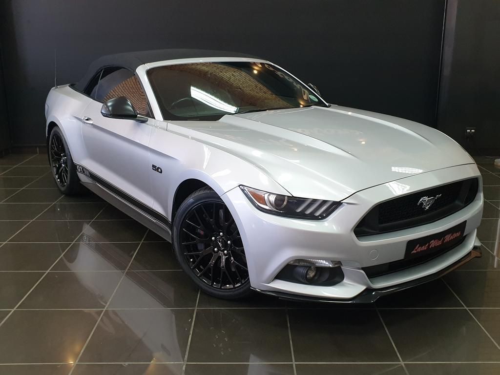 White Ford Mustang GT convertible displayed in showroom