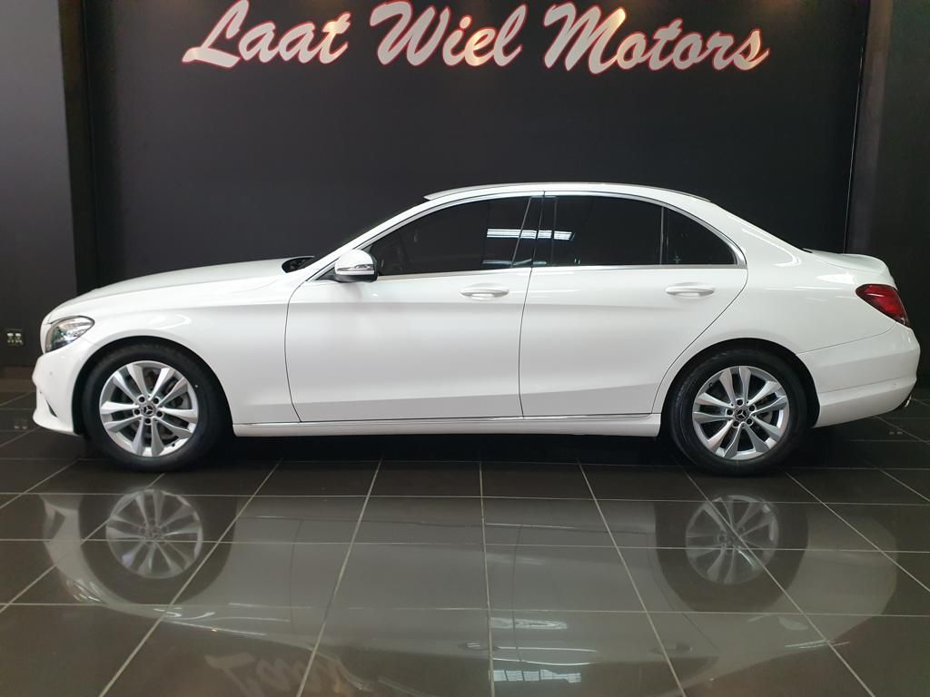White luxury sedan displayed in a showroom
