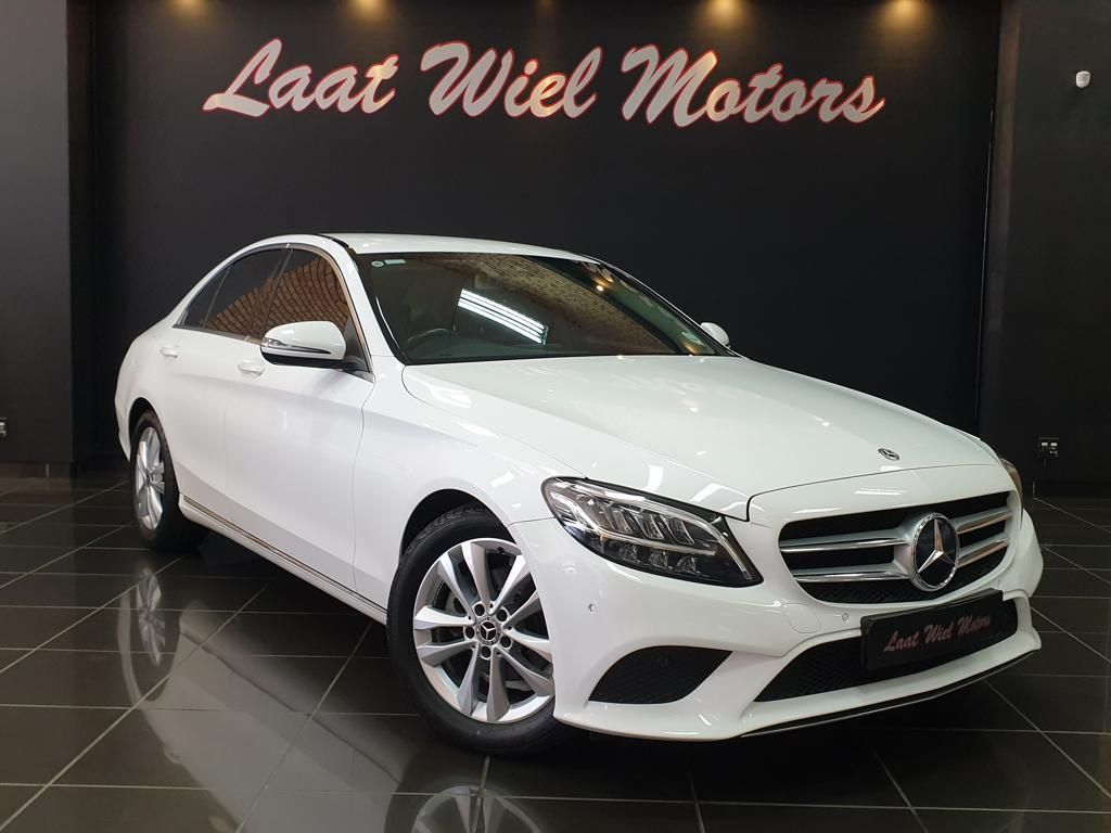 White Mercedes-Benz sedan displayed in a showroom