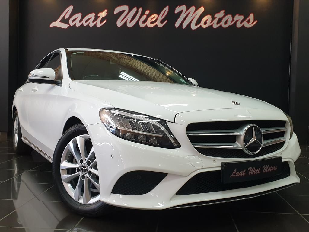 White Mercedes-Benz sedan displayed in Laast Wiel Motors showroom
