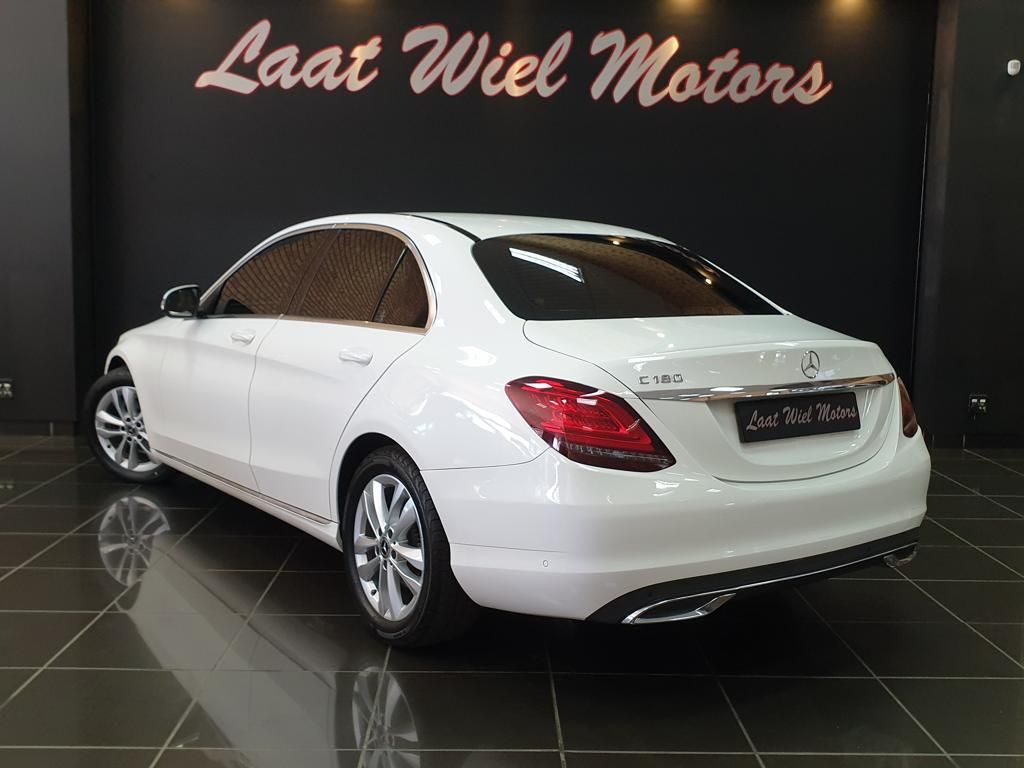 White Mercedes-Benz C-Class sedan displayed in a showroom