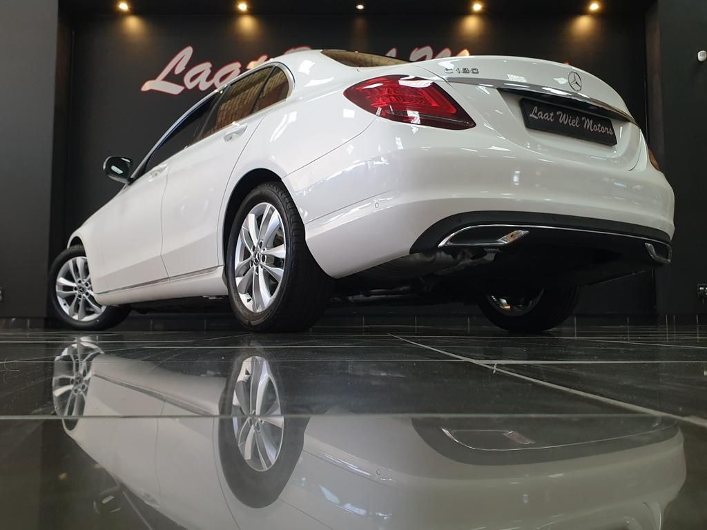 White Mercedes-Benz sedan displayed in a showroom