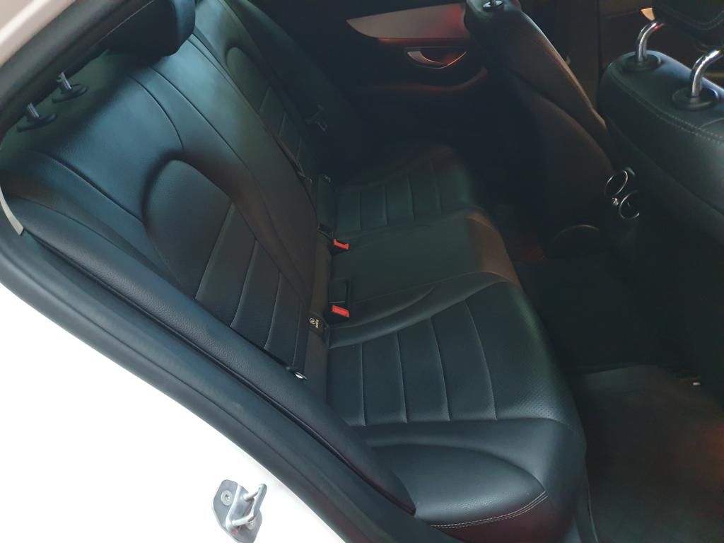 Black leather rear seats and center console inside a car