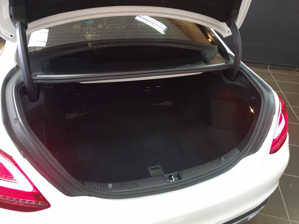 Open trunk of a white sedan showing spacious cargo area