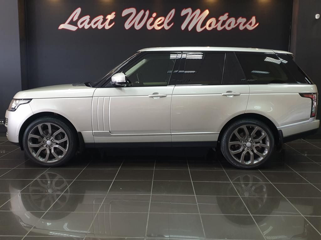 White Range Rover displayed in a luxury car showroom