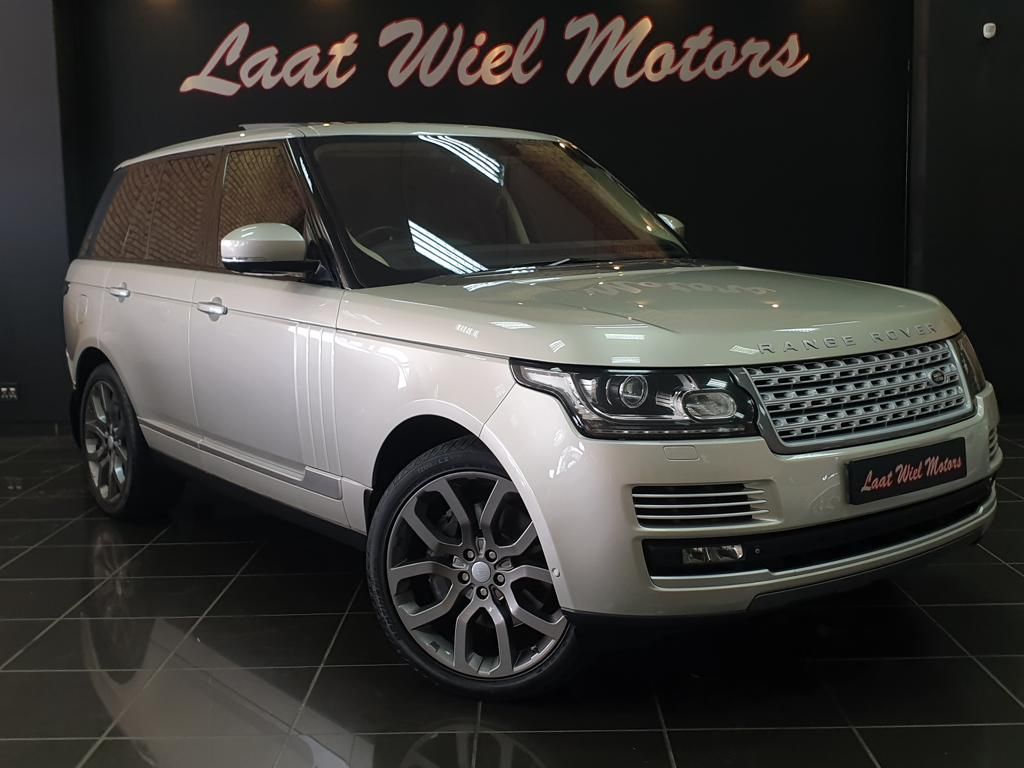 White Range Rover displayed in a luxury car showroom