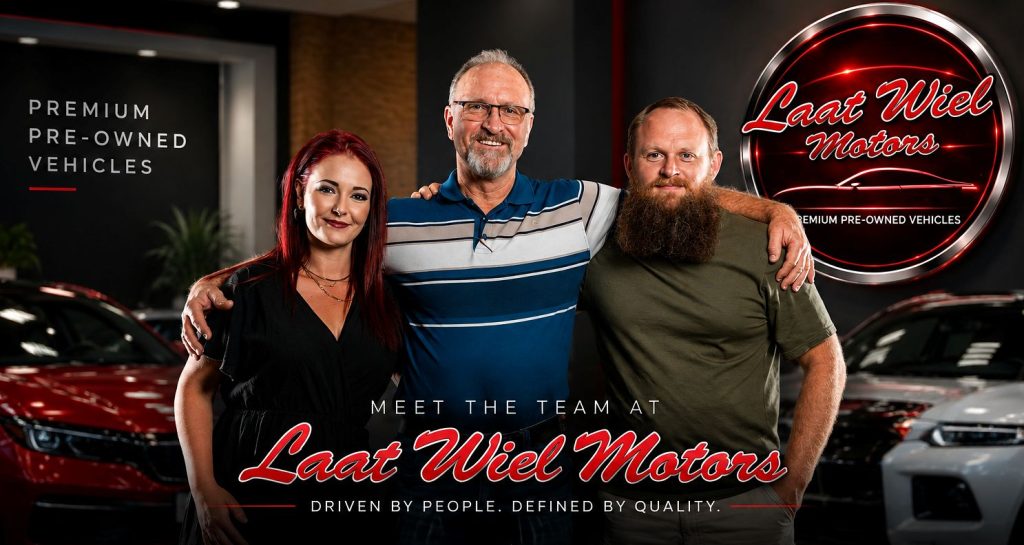 Laat Wiel Motors team standing between premium pre-owned vehicles